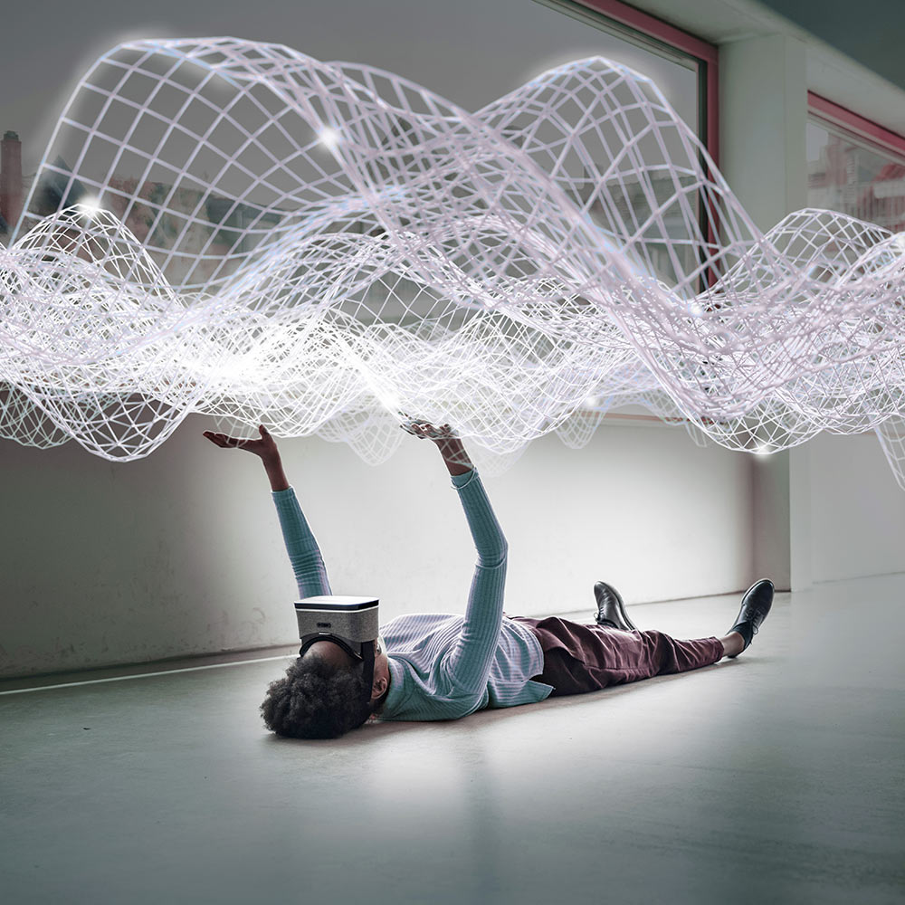 A person with a VR headset laying down and looking at a net of lights