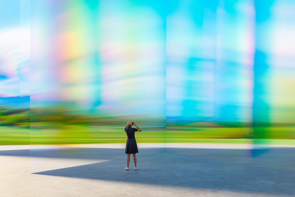 AI Services image: A woman wearing a VR headset in a futuristic world.