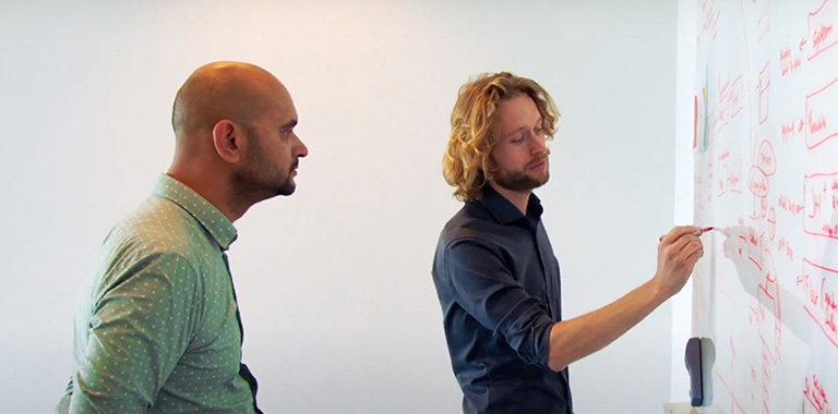 Erik van Roon: a man writing on a whiteboard