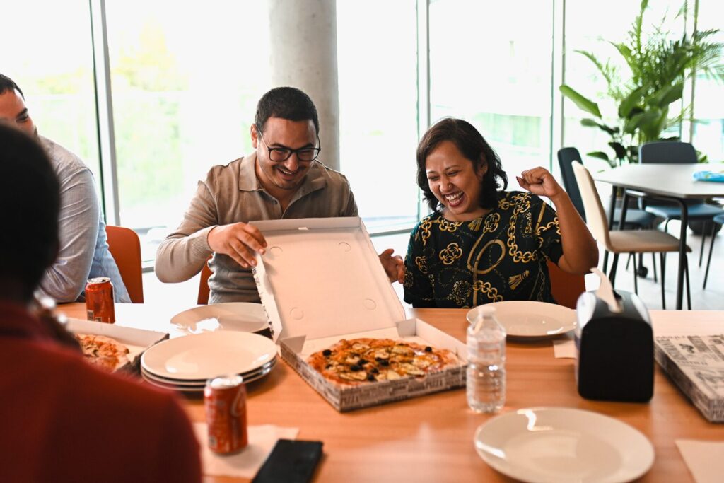 A team of people eating pizza