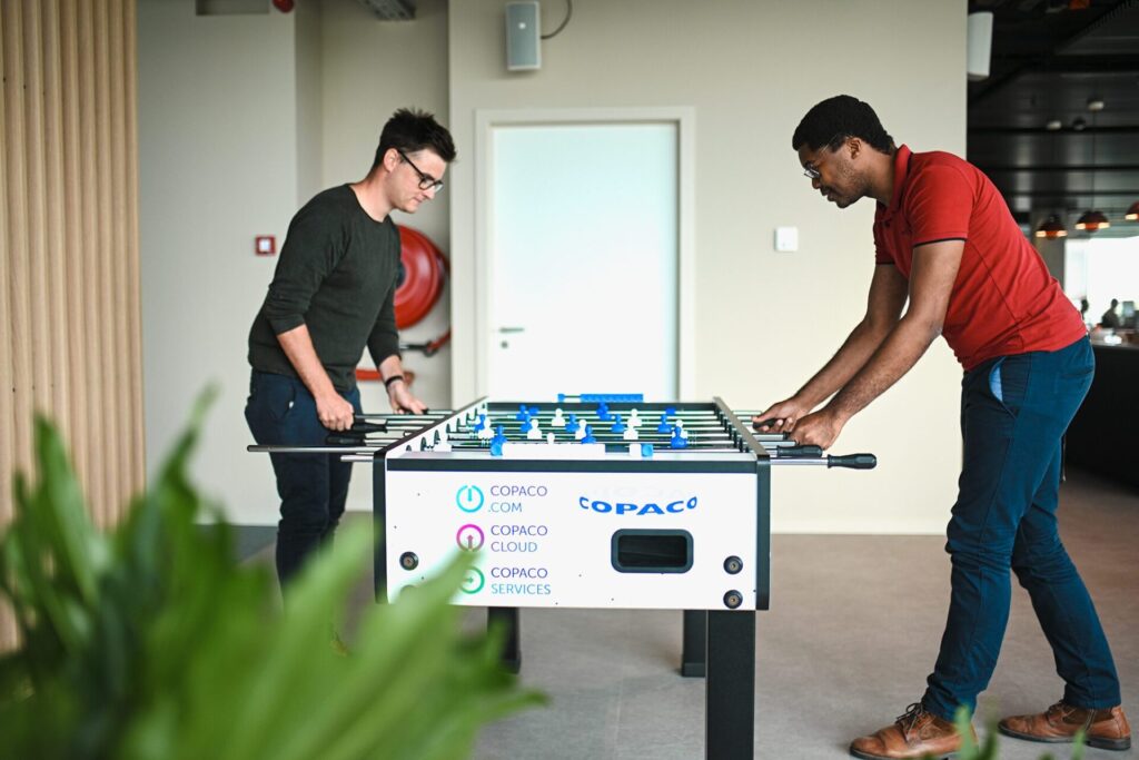 Two men playing foosball 