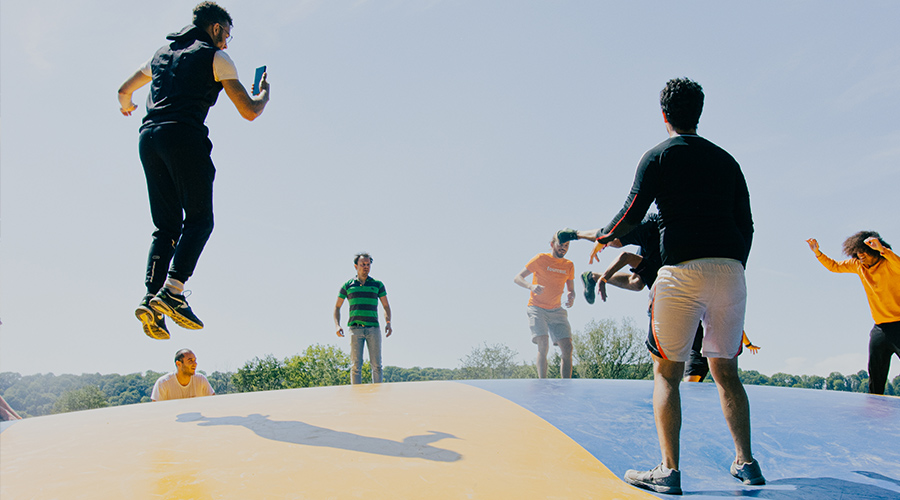 google cloud team: a group of people jumping on a trampoline