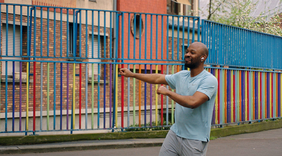 A man listening to the music on his headphones and dancing