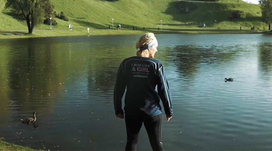 Megan Atkinson Hobson: A woman standing by the lake.