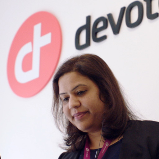 A woman with a Devoteam logo in the background